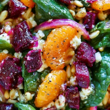 Beet salad with spinach and mandarin oranges in a bowl