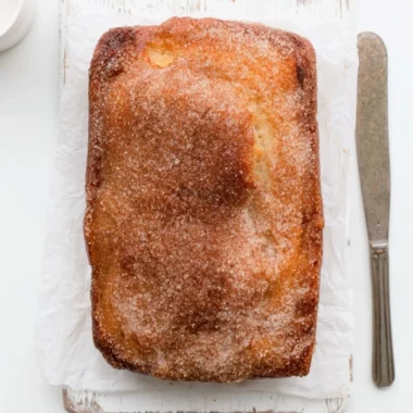 Cinnamon Sugar Donut Bread fresh out of the oven, topped with a sprinkle of cinnamon sugar.