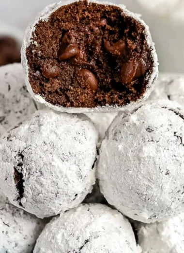 Freshly baked Double Chocolate Snowball Cookies dusted with powdered sugar