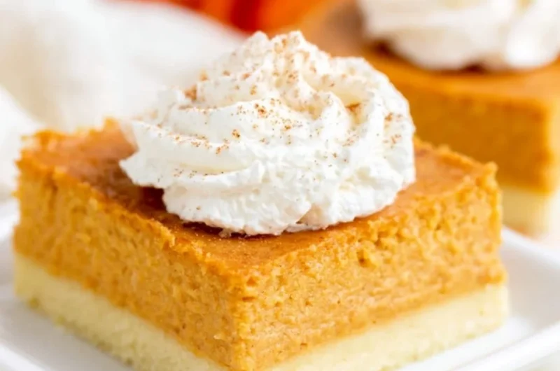 Pumpkin pie bars on a plate with buttery shortbread crust