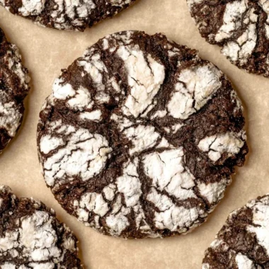 Delicious chocolate crinkle cookies dusted with powdered sugar on a plate.