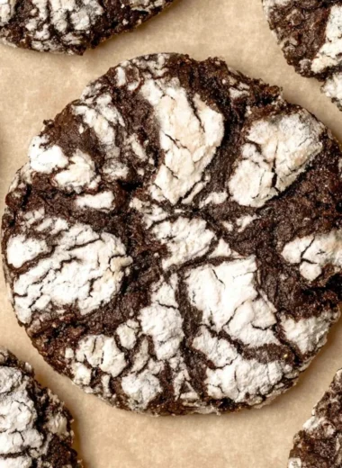 Delicious chocolate crinkle cookies dusted with powdered sugar on a plate.