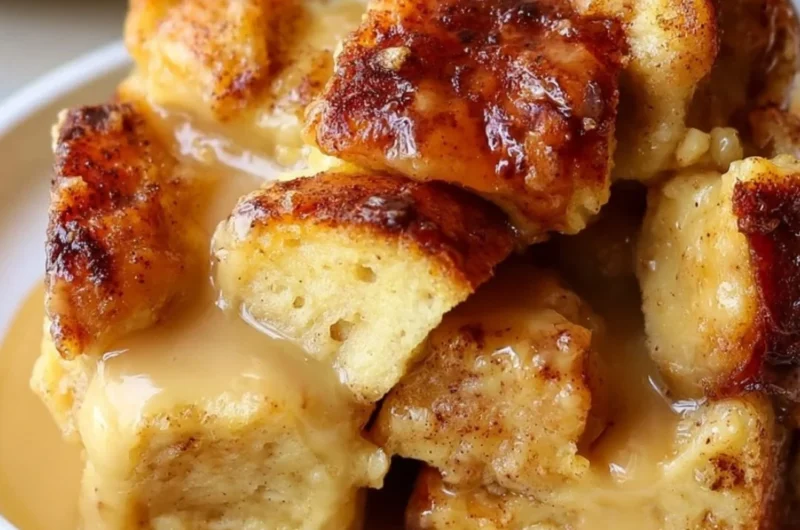 Delicious bread pudding with vanilla caramel sauce served in a dessert dish.