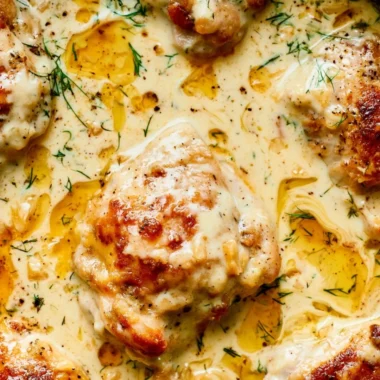 Creamy oven baked chicken thighs served with herbs and spices