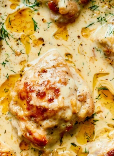 Creamy oven baked chicken thighs served with herbs and spices