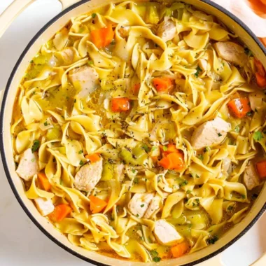 Delicious Dutch Oven Chicken Noodle Soup in a rustic pot