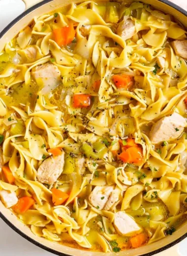 Delicious Dutch Oven Chicken Noodle Soup in a rustic pot