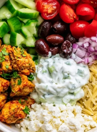 High-protein chicken gyro bowl with fresh vegetables and sauce