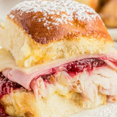 Delicious easy cheesy Monte Cristo sliders ready to serve on a platter.