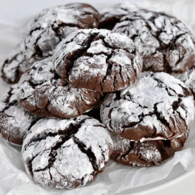 Baking easy chocolate crinkle cookies with powdered sugar coating.