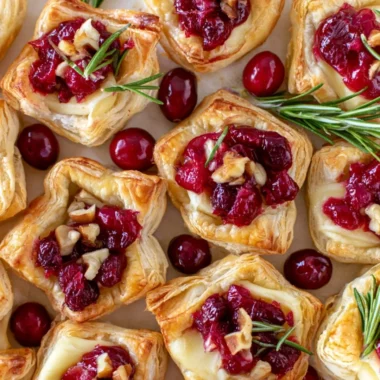 Delicious Cranberry Brie Bites with puff pastry on a serving platter