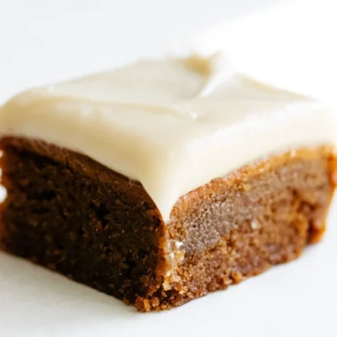 Gingerbread cookie bars with cream cheese frosting on a festive table