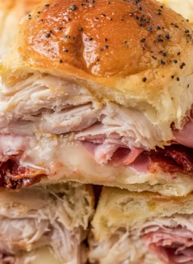 Buttery baked club sliders fresh out of the oven, ready to be served as a tasty snack.