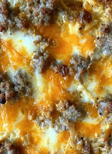 Sausage Hashbrown Breakfast Casserole topped with cheese and herbs