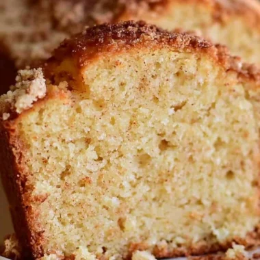 Delicious spiced Eggnog Loaf garnished with holiday spices and a dusting of powdered sugar.