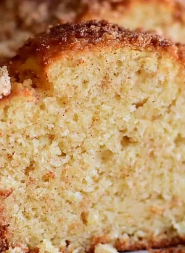 Delicious spiced Eggnog Loaf garnished with holiday spices and a dusting of powdered sugar.
