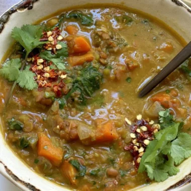Bowl of sweet potato lentil stew with vibrant vegetables and spices