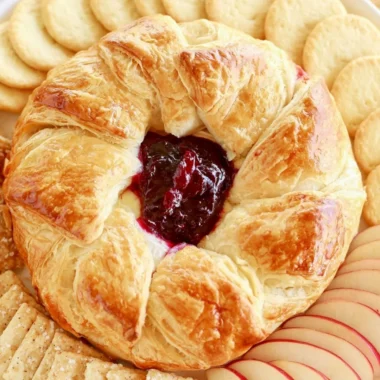 Delicious Baked Brie in Puff Pastry topped with berries and nuts.
