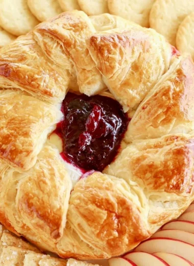 Delicious Baked Brie in Puff Pastry topped with berries and nuts.