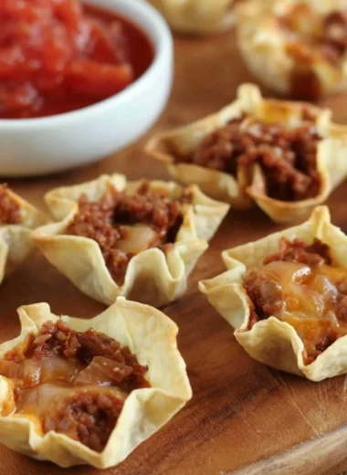 Tortilla nacho cups filled with cheese and toppings ready to serve